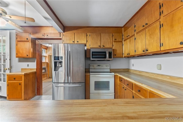 672 Main St, Dillwyn, VA 23936 - kitchen with appliances with stainless steel finishes, a ceiling fan, light countertops, and brown cabinets