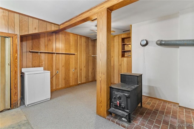 672 Main St, Dillwyn, VA 23936 - below grade area featuring a wood stove, wooden walls, and refrigerator
