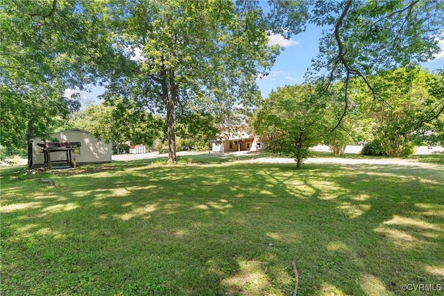 672 Main St, Dillwyn, VA 23936 - view of green lawn with view of wooded area