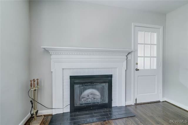 9019 Farmington Dr, Henrico, VA 23229 - detailed view of a brick fireplace, wood finished floors, and baseboards