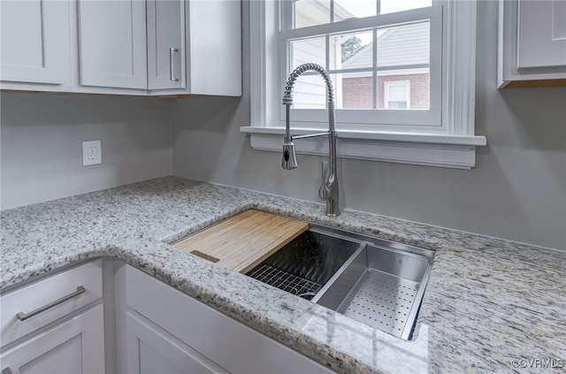 9019 Farmington Dr, Henrico, VA 23229 - kitchen view of a sink, white cabinets, and light stone countertops