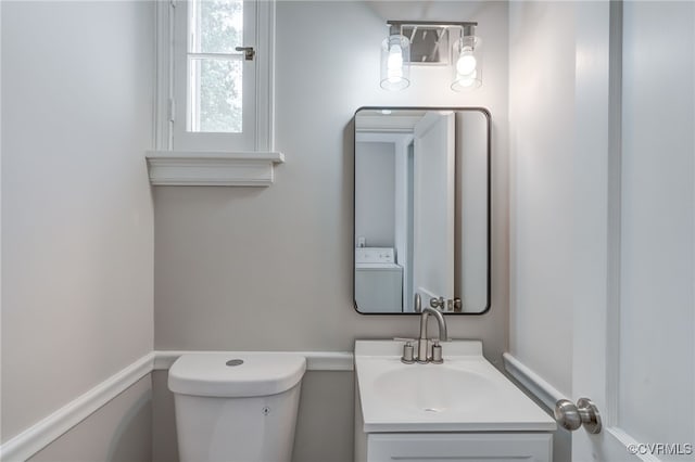 9019 Farmington Dr, Henrico, VA 23229 - bathroom with washer / dryer, toilet, and vanity
