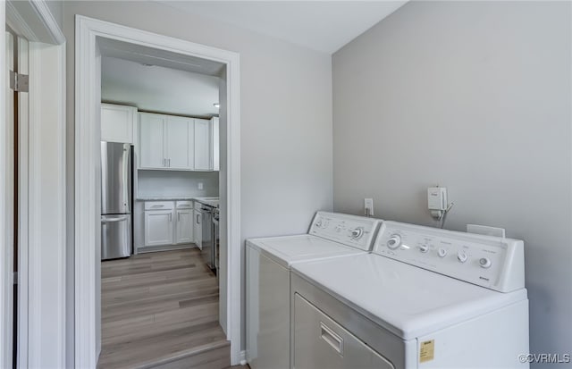 9019 Farmington Dr, Henrico, VA 23229 - laundry room featuring washing machine and dryer and light wood-type flooring