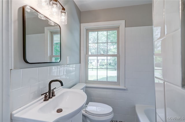 9019 Farmington Dr, Henrico, VA 23229 - bathroom featuring tile walls, toilet, healthy amount of natural light, and a sink