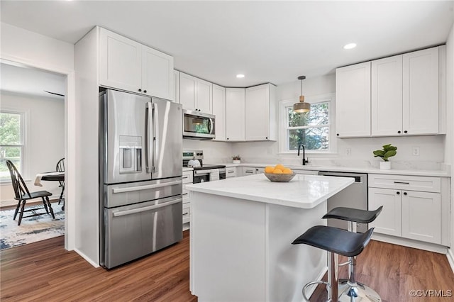1307 Unison Dr, Chesterfield, VA 23113 - kitchen with appliances with stainless steel finishes, healthy amount of natural light, a breakfast bar, white cabinets, and recessed lighting