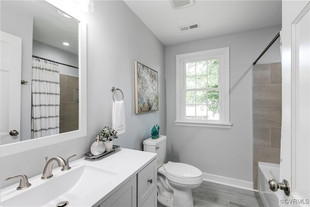 6256 Nicolet Rd, Richmond, VA 23225 - bathroom with vanity, toilet, wood finished floors, baseboards, and shower / tub combo with curtain