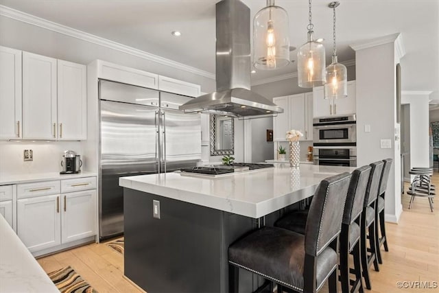 4820 Old Main St Unit 604, Henrico, VA 23231 - kitchen with island exhaust hood, appliances with stainless steel finishes, ornamental molding, light wood-type flooring, and white cabinetry