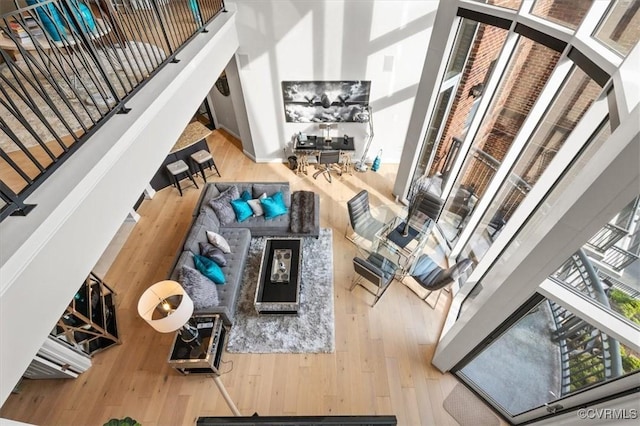 4820 Old Main St Unit 604, Henrico, VA 23231 - living room with plenty of natural light, hardwood / wood-style floors, a towering ceiling, and stairs