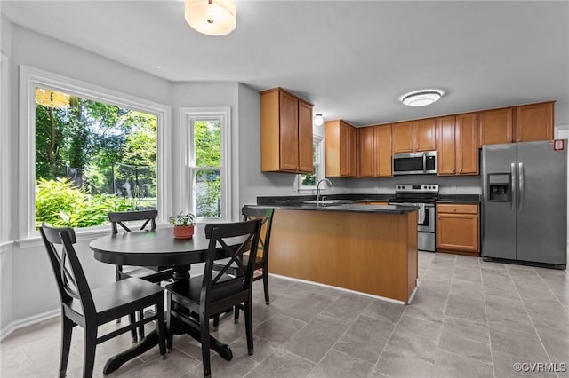10112 Huntersdell Ln, Chesterfield, VA 23235 - kitchen with appliances with stainless steel finishes, dark countertops, a peninsula, and brown cabinets