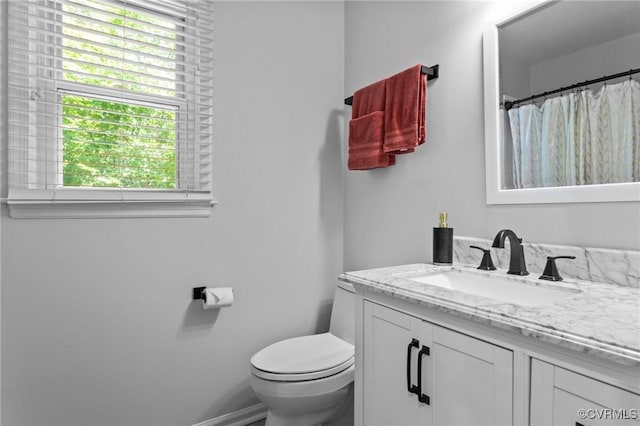 10112 Huntersdell Ln, Chesterfield, VA 23235 - full bathroom featuring vanity, toilet, healthy amount of natural light, and baseboards