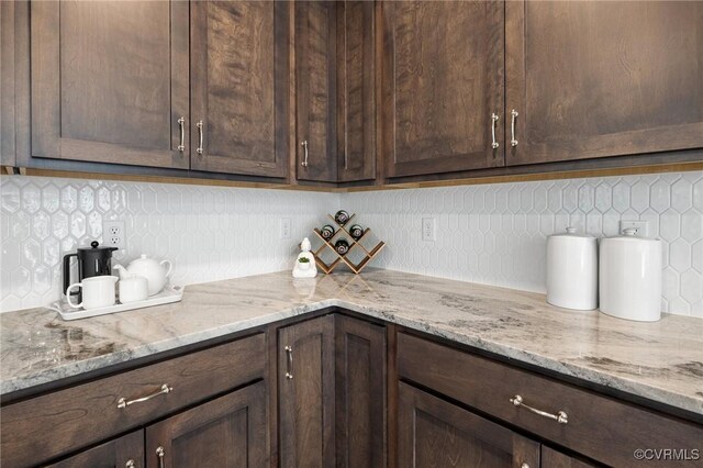 11183 Pinewild Dr, Providence Forge, VA 23140 - kitchen featuring dark brown cabinets, tasteful backsplash, and light stone counters