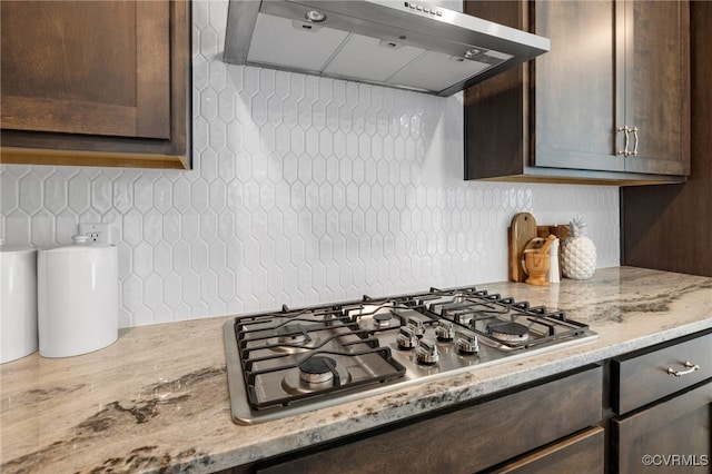 11183 Pinewild Dr, Providence Forge, VA 23140 - kitchen with exhaust hood, dark brown cabinets, stainless steel gas cooktop, tasteful backsplash, and light stone countertops