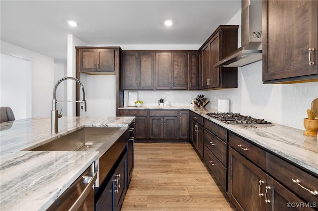 11183 Pinewild Dr, Providence Forge, VA 23140 - kitchen with wall chimney range hood, stainless steel appliances, light wood-type flooring, light stone counters, and dark brown cabinets