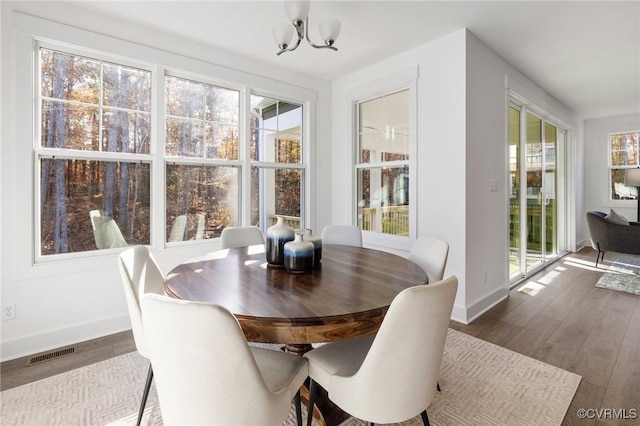11183 Pinewild Dr, Providence Forge, VA 23140 - dining space with baseboards, dark wood-type flooring, and a chandelier