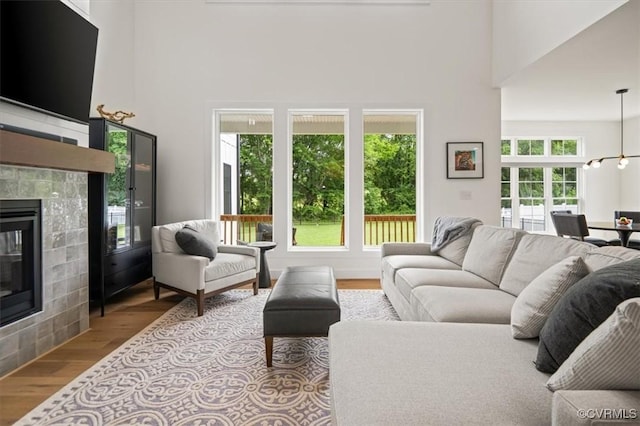 333 Pond View Ln, Goochland, VA 23103 - living area with a tile fireplace, wood finished floors, and a high ceiling