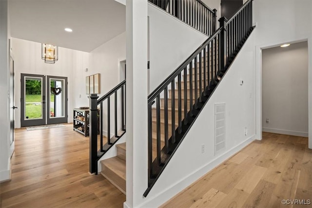 333 Pond View Ln, Goochland, VA 23103 - stairway with wood finished floors, a chandelier, a towering ceiling, and recessed lighting