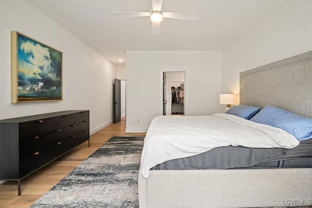 333 Pond View Ln, Goochland, VA 23103 - bedroom featuring light wood finished floors, a spacious closet, a ceiling fan, a closet, and recessed lighting