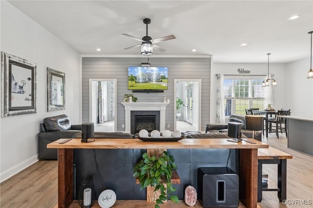 3381 Holywell Cir, Powhatan, VA 23139 - living area featuring baseboards, recessed lighting, wood finished floors, a ceiling fan, and a glass covered fireplace