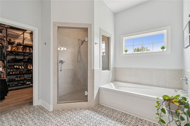 3381 Holywell Cir, Powhatan, VA 23139 - full bathroom featuring a shower stall, a garden tub, a spacious closet, and tile patterned flooring
