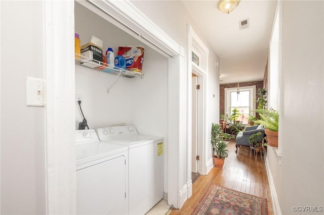 1701 W Leigh St, Richmond, VA 23220 - laundry area with light wood-style flooring, washing machine and dryer, and baseboards