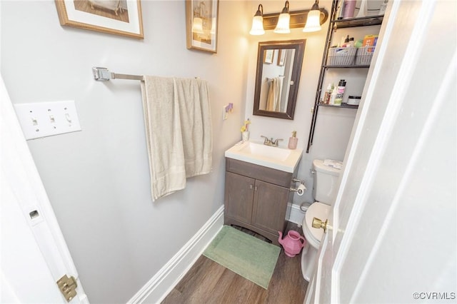 1701 W Leigh St, Richmond, VA 23220 - bathroom featuring vanity, wood finished floors, toilet, and baseboards