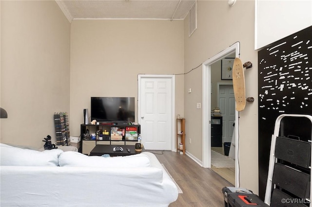 1701 W Leigh St, Richmond, VA 23220 - bedroom with a towering ceiling, wood finished floors, crown molding, and baseboards