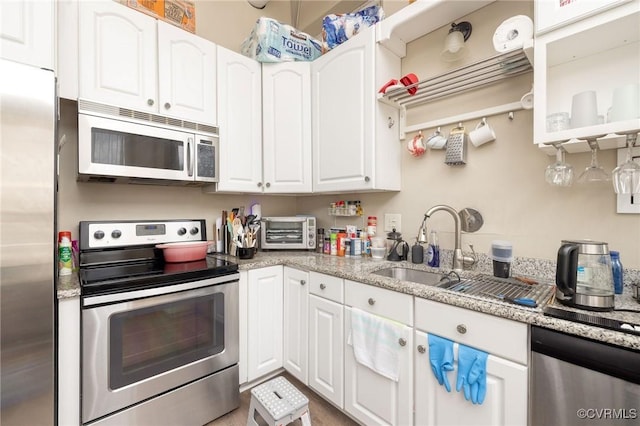 1701 W Leigh St, Richmond, VA 23220 - kitchen featuring stainless steel appliances, a sink, white cabinets, and light stone countertops