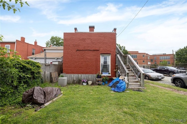 1701 W Leigh St, Richmond, VA 23220 - rear view of house with central air condition unit and a chimney