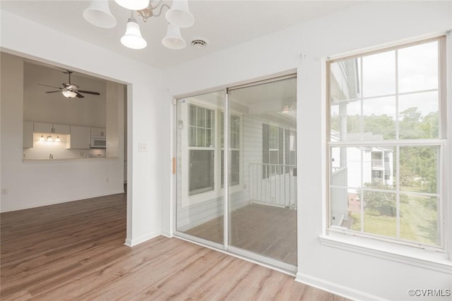 9394 Wind Haven Ct Unit 309, Henrico, VA 23060 - unfurnished sunroom featuring a chandelier
