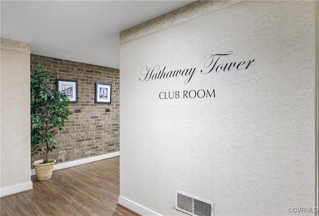 2956 Hathaway Rd Unit 803, Richmond, VA 23225 - hall featuring baseboards, wood finished floors, and brick wall