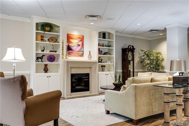 2956 Hathaway Rd Unit 803, Richmond, VA 23225 - living area with ornamental molding, wood finished floors, a glass covered fireplace, and built in features