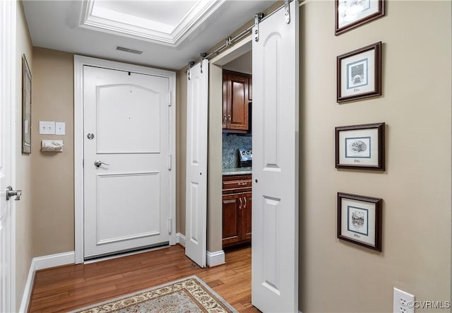 2956 Hathaway Rd Unit 803, Richmond, VA 23225 - foyer with a barn door, wood finished floors, and baseboards