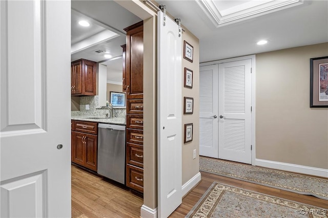 2956 Hathaway Rd Unit 803, Richmond, VA 23225 - kitchen with dishwasher, light wood-style flooring, a sink, baseboards, and a barn door
