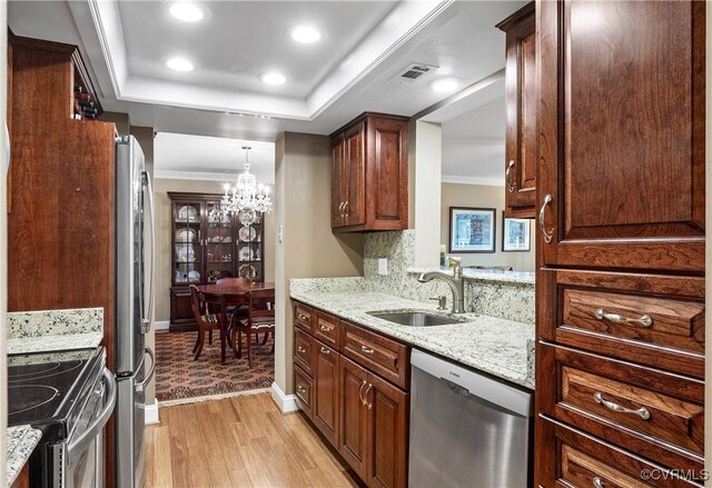 2956 Hathaway Rd Unit 803, Richmond, VA 23225 - kitchen with appliances with stainless steel finishes, a sink, a chandelier, crown molding, and light wood-type flooring