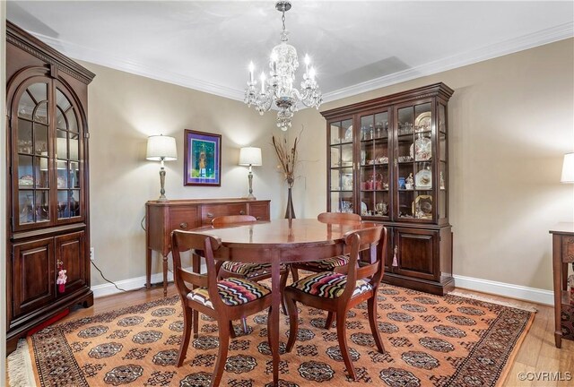 2956 Hathaway Rd Unit 803, Richmond, VA 23225 - dining area with a chandelier, light wood-style flooring, baseboards, and crown molding
