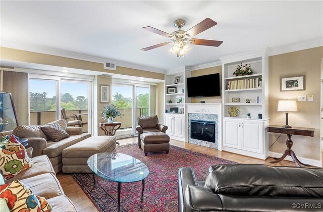 2956 Hathaway Rd Unit 803, Richmond, VA 23225 - living area featuring light wood-style flooring, ceiling fan, a premium fireplace, ornamental molding, and built in features