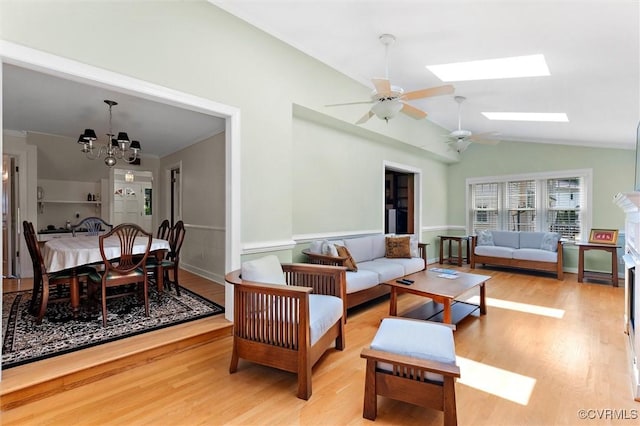 2730 Dalkeith Dr, Henrico, VA 23233 - living area featuring light wood-style flooring, ceiling fan, a chandelier, lofted ceiling, and a wainscoted wall
