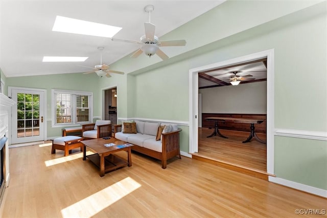 2730 Dalkeith Dr, Henrico, VA 23233 - living room featuring light wood finished floors, ceiling fan, a skylight, vaulted ceiling, and wainscoting