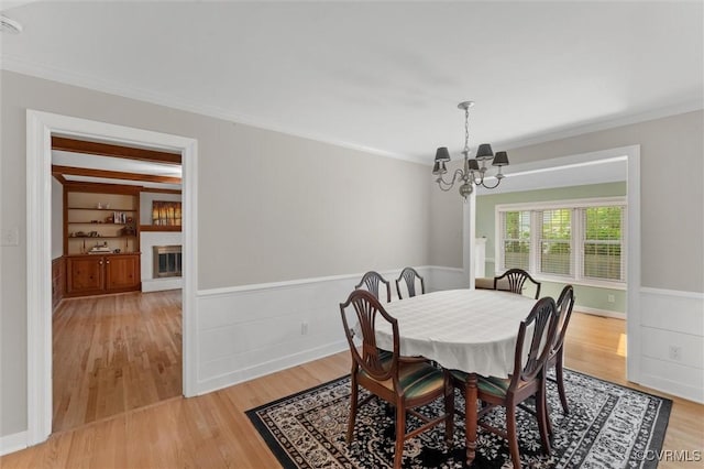 2730 Dalkeith Dr, Henrico, VA 23233 - dining room with a chandelier, ornamental molding, light wood-type flooring, and a wainscoted wall