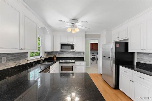 2730 Dalkeith Dr, Henrico, VA 23233 - kitchen with stainless steel appliances, a sink, washing machine and clothes dryer, white cabinets, and ornamental molding