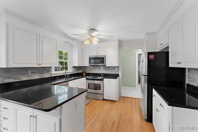 2730 Dalkeith Dr, Henrico, VA 23233 - kitchen with stainless steel appliances, a peninsula, white cabinetry, and ornamental molding