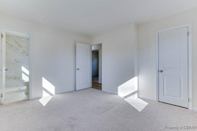 525 Helm Dr, Newport News, VA 23602 - unfurnished bedroom with carpet, baseboards, and ensuite bath