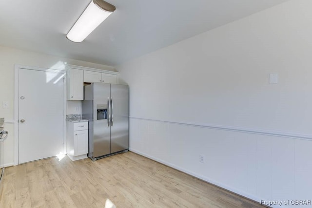 525 Helm Dr, Newport News, VA 23602 - kitchen with stainless steel fridge, white cabinets, light wood finished floors, and light stone counters