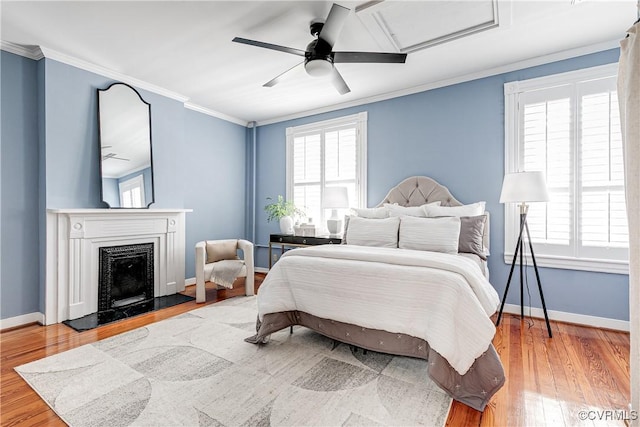 2210 Stuart Ave, Richmond, VA 23220 - bedroom featuring wood finished floors, multiple windows, baseboards, and crown molding