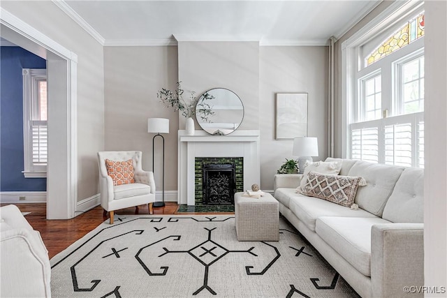 2210 Stuart Ave, Richmond, VA 23220 - living area featuring crown molding, wood finished floors, a tiled fireplace, and baseboards