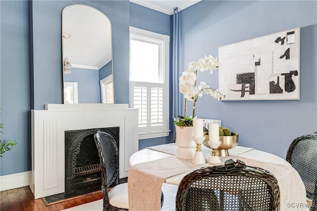 2210 Stuart Ave, Richmond, VA 23220 - dining space with ornamental molding, plenty of natural light, a fireplace with flush hearth, wood finished floors, and baseboards