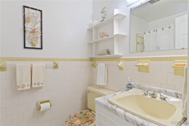 2133 Bloomsherry Dr, Chesterfield, VA 23235 - bathroom featuring vanity, toilet, a wainscoted wall, tile walls, and a shower with shower curtain