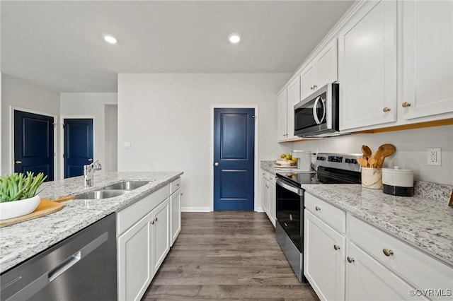 111 Leonard Ct, King William, VA 23009 - kitchen with appliances with stainless steel finishes, a sink, white cabinets, dark wood finished floors, and light stone countertops