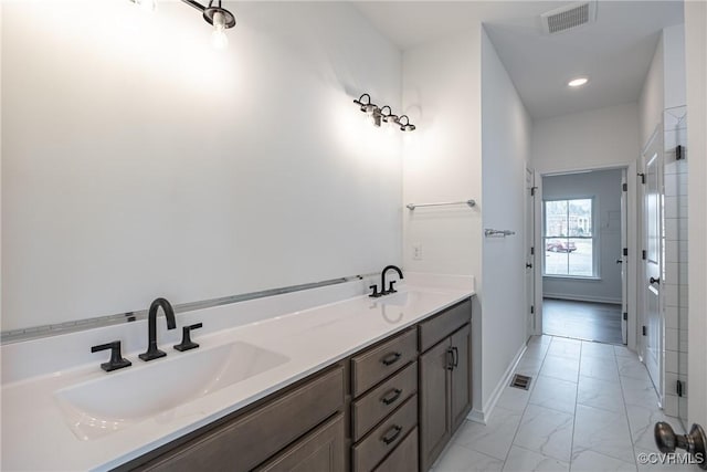 15124 Johns Trace Cir, Montpelier, VA 23192 - bathroom featuring marble look tile flooring, double vanity, baseboards, and recessed lighting