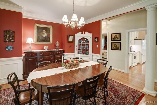 423 Elm Creek Dr, Manakin Sabot, VA 23103 - dining room with decorative columns, a chandelier, light wood-style flooring, crown molding, and a wainscoted wall